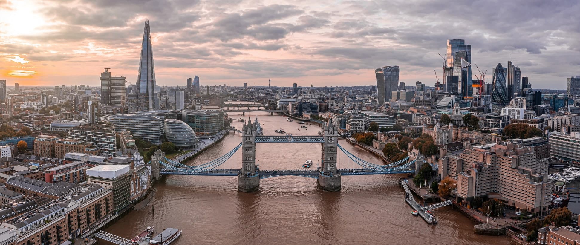 London from the river at dusk, showing Tower Bridge and the City